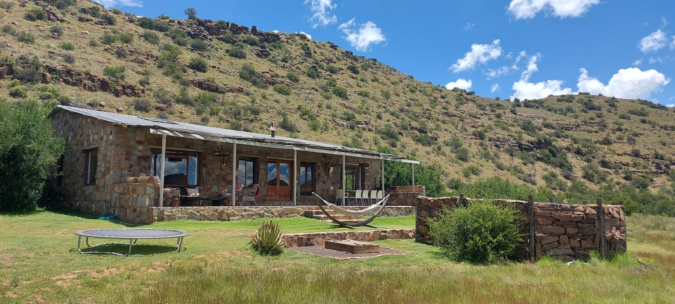 The River Lodge at Karoo Ridge Conservancy, its stone exterior looking out over the Groot-Brak River valley